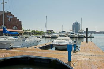 Many boats are docked at a dock in a marina